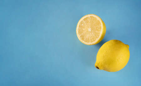 Lemons isolated on blue background. Summer backgroundの写真素材