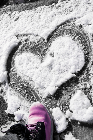 Heart drawn on the snowの写真素材