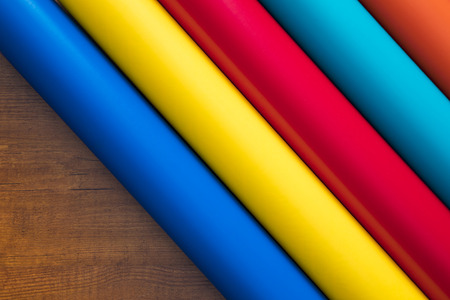 Colored vinyl rolls over wooden backgroundの写真素材