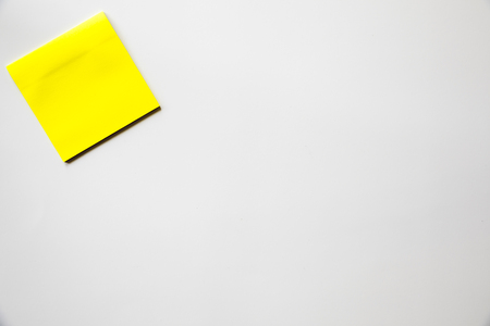 yellow sticker note over white background