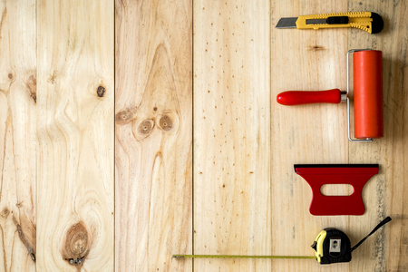 Colorful vinyl rolls on wooden background with your necessary instruments
