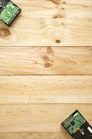 HDD and computer components to fix on wooden background with space for textの写真素材