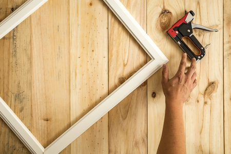 Hand made to catch tool and frame on wooden background