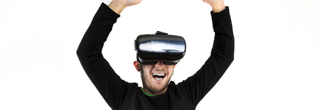 Panned bearded happy young man with modern glasses with virtual reality simulator isolated over...