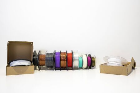 3D printing filament reels for 3d printers in boxes in boxes on white background