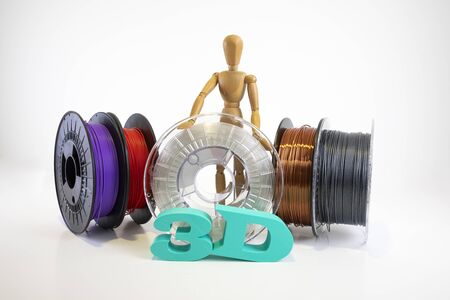 3D printing filament reels with wooden anthropomorphic doll with textの写真素材