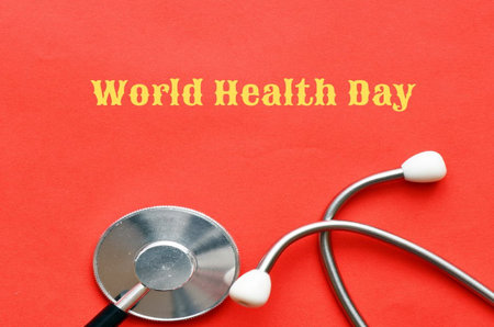 World Health Day concept with stethoscope on red paper background.の写真素材