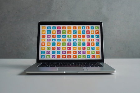 Laptop with colorful application icons on the screen on a white tableの素材