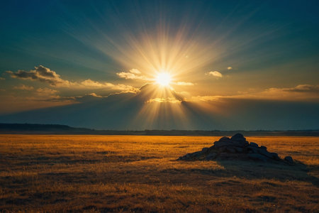 Sunset over a meadow with a stone in the foreground.の素材