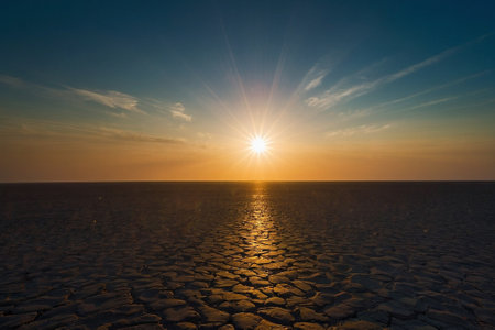 Sunset over dry land, global warming and climate change concept.の素材