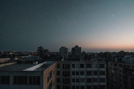 Night sky with stars over the city. Cityscape of the city.の素材