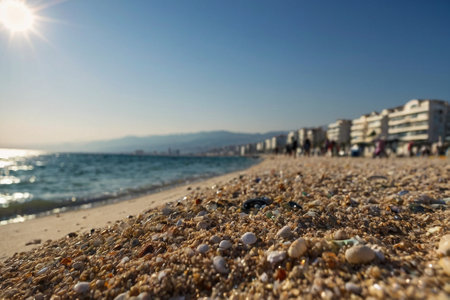 Beach with pebbles and shells on the background of the sunの素材