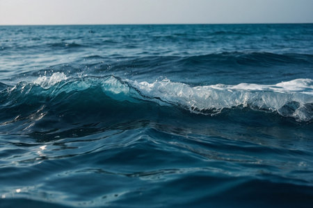 Sea wave on a background of blue water. Sea wave in the ocean.の素材