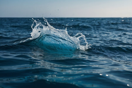 Blue wave in the sea with splashes and drops of water.の素材