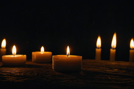 Burning candles on wooden table, closeup. Space for textの素材