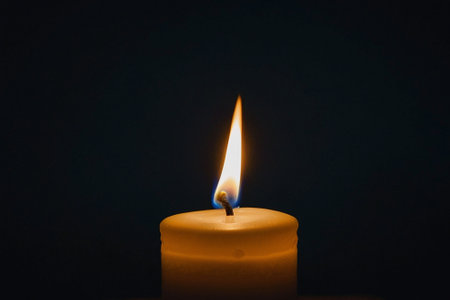 Candle on a black background, close-up, selective focusの素材
