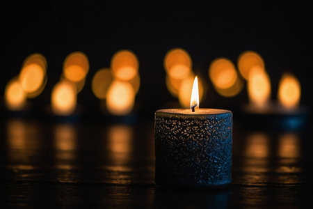 Burning candle in the dark with bokeh light background.の素材