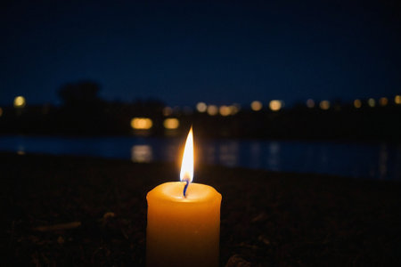 Candle on the bank of the river at night. Selective focus.の素材