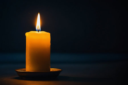 Burning candle on dark background with copy space for your text.の素材