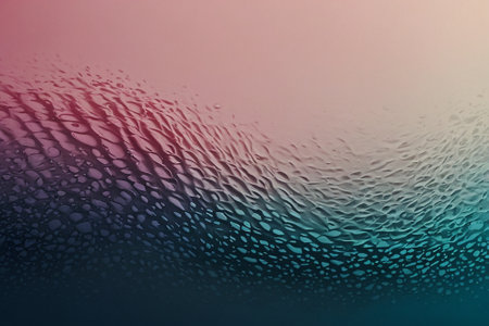 raindrops on glass with a gradient blue-pink background.の素材