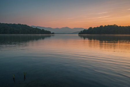 Sunset on the lake with mountains in the background. Landscape.の素材