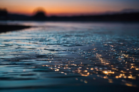 Raindrops on the surface of the water at sunset, close-upの素材