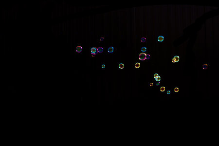 Colorful soap bubbles on a black background. Blur effect.の写真素材