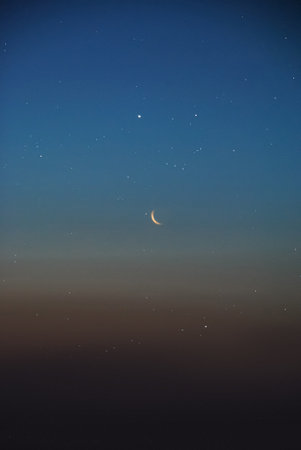 Crescent moon in the night sky. Night sky with stars.