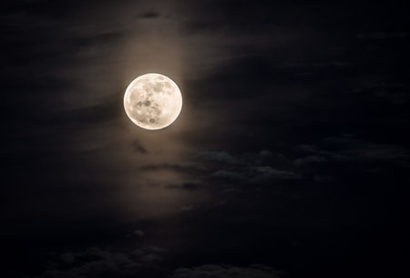 Full moon in the night sky with clouds and stars. Halloween backgroundの写真素材