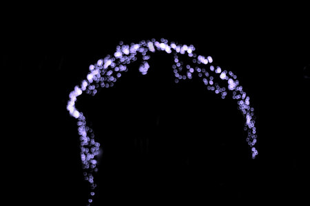 Purple lights on a black background in the form of a waveの写真素材