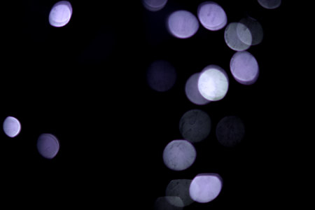 Abstract circular bokeh background of Christmaslight on black background.の写真素材