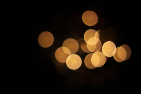 Abstract circular bokeh background of Christmaslight on black background.の写真素材