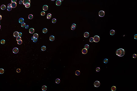 Soap bubbles on a black background. Shallow depth of field.の写真素材