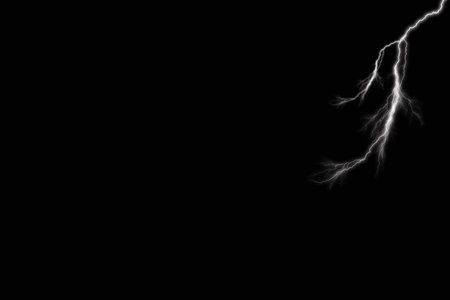 Lightning strike over a black background with space for text or imageの写真素材
