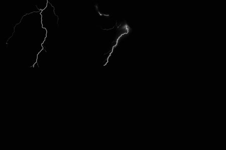 Lightning strike on a black background with space for your text.の写真素材