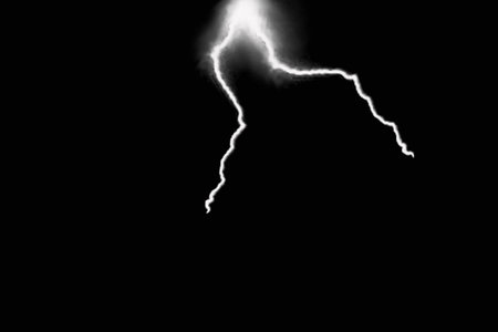 Lightning bolt isolated on black background. Thunderstorm lightning strike.の写真素材
