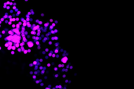 Abstract bokeh light background. Defocused lights on black background.