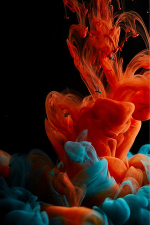 Abstract paint splash isolated on black background. Colorful ink in water.の写真素材