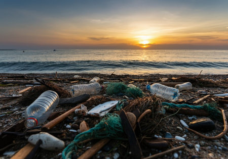 Plastic waste on the beach at sunset. Environmental pollution concept.