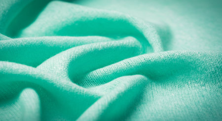 Texture, background, pattern. The fabric is knitted turquoise, pastel green, with a brilliant shine. If you have a bad mood, this fabric will lift it to unprecedented heights.の写真素材