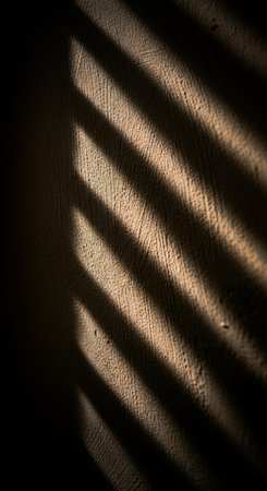 shadow on the wall in the dark room with light from the windowの写真素材