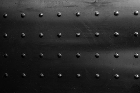 Metal plate with rivets in black and white. Abstract background and texture for design.の写真素材