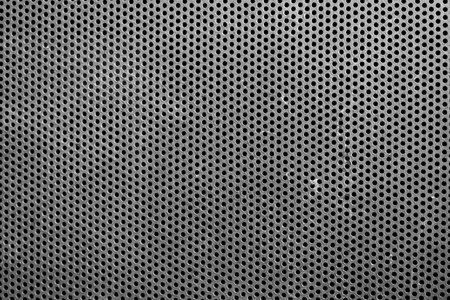 abstract black and white background of metal perforated with holesの写真素材
