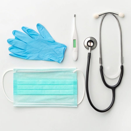 Medical mask, gloves, thermometer and stethoscope on white backgroundの写真素材