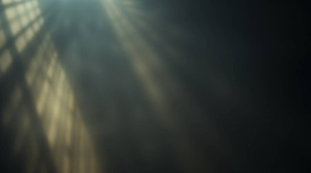 Sun rays on a black background. Sunbeams through the window.の写真素材