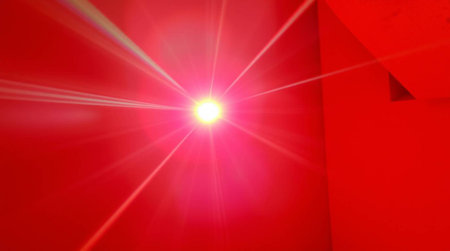 abstract red background with lens flare and bokeh effect.