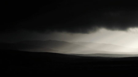Dramatic sky with sunbeams and fog over hills.