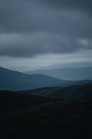 Mountain landscape with dark clouds in the sky. View from the top of the mountain.の写真素材