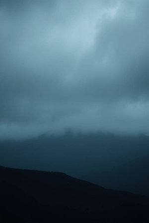 Foggy landscape in the mountains. Dark foggy sky.の写真素材