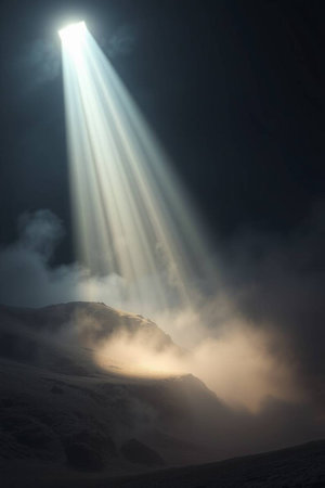 Beautiful view of the sun rays through the clouds in the mountainsの写真素材